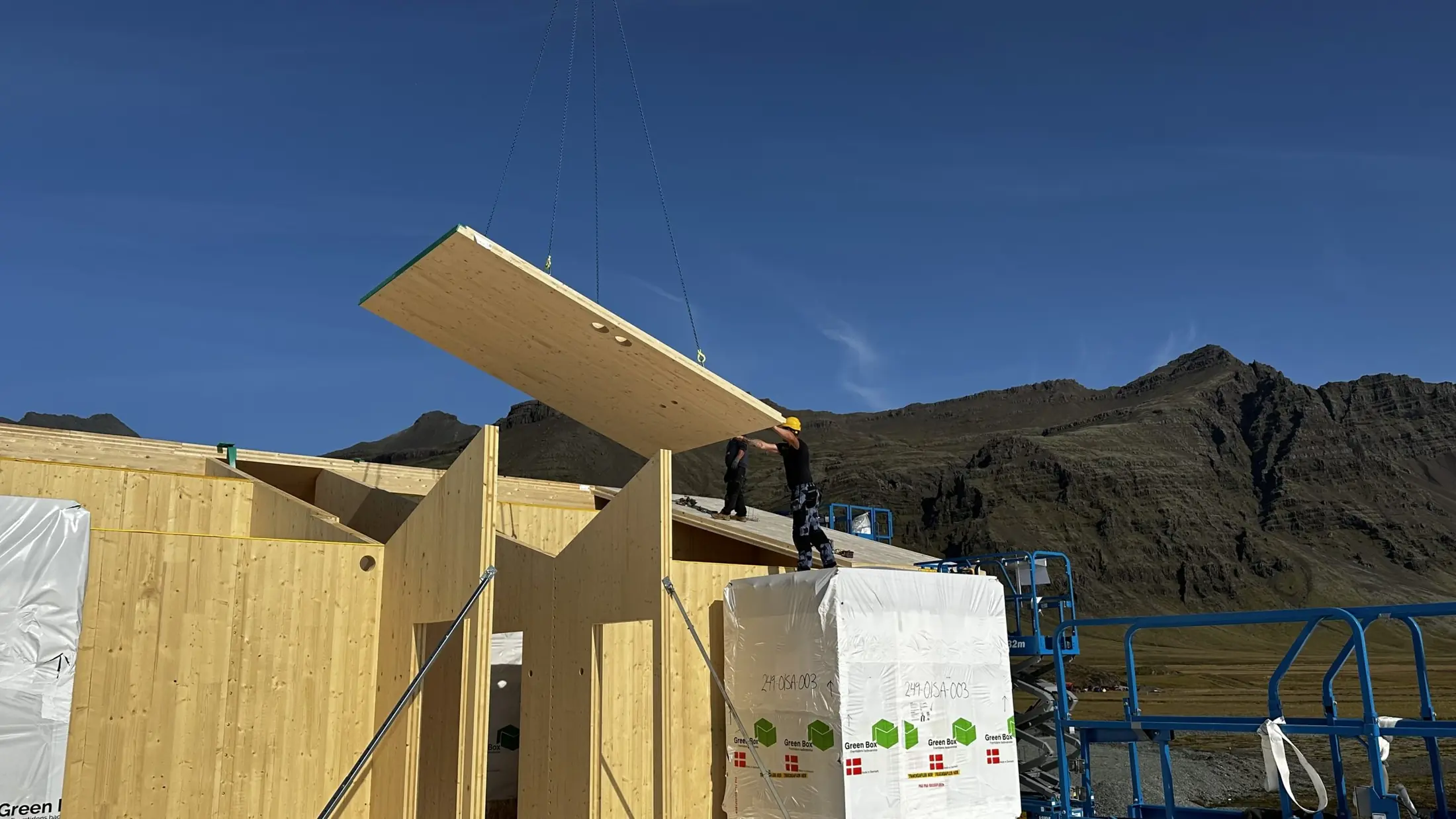 A CLT panel lifted into place on site